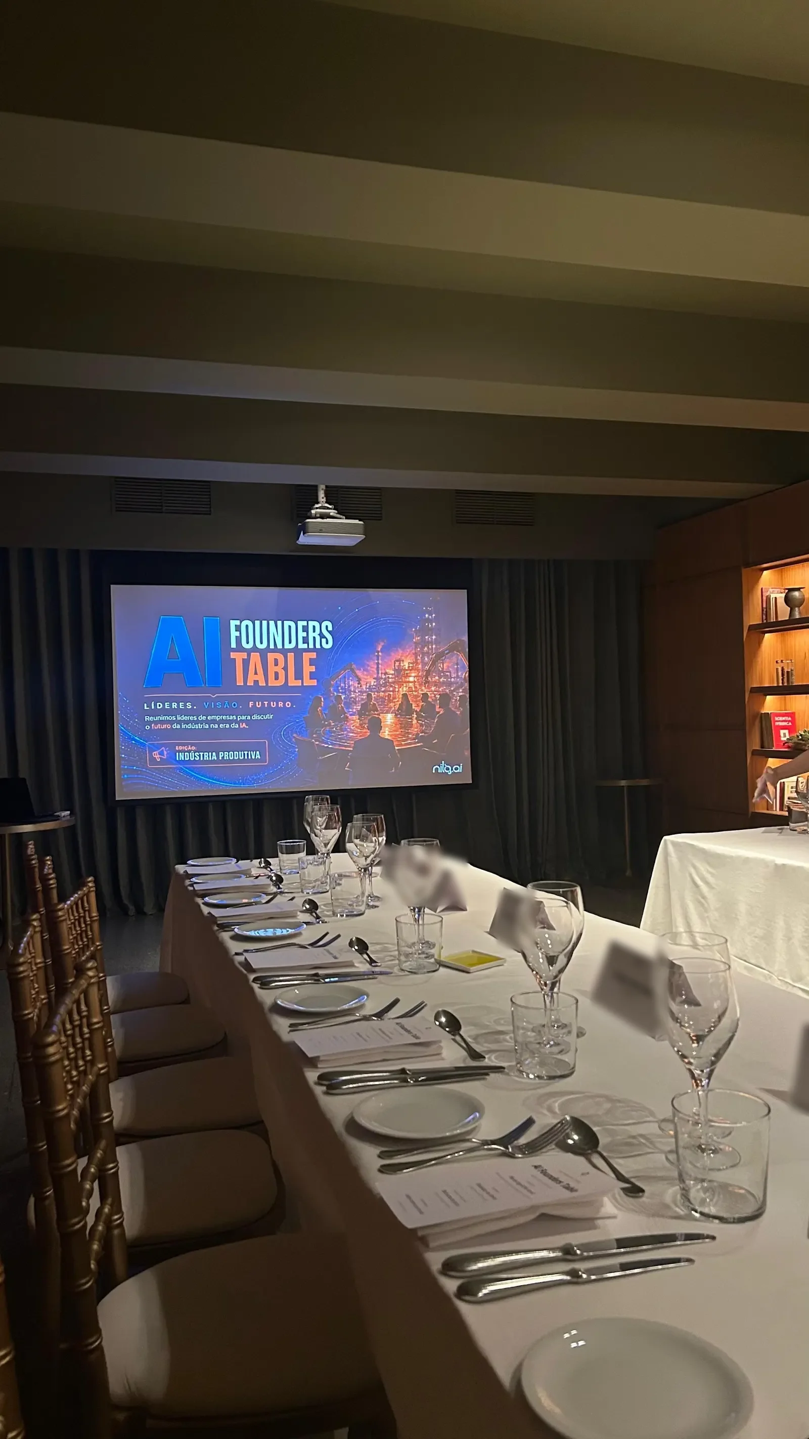 The long table of the manufacturing edition, with the screen at the back