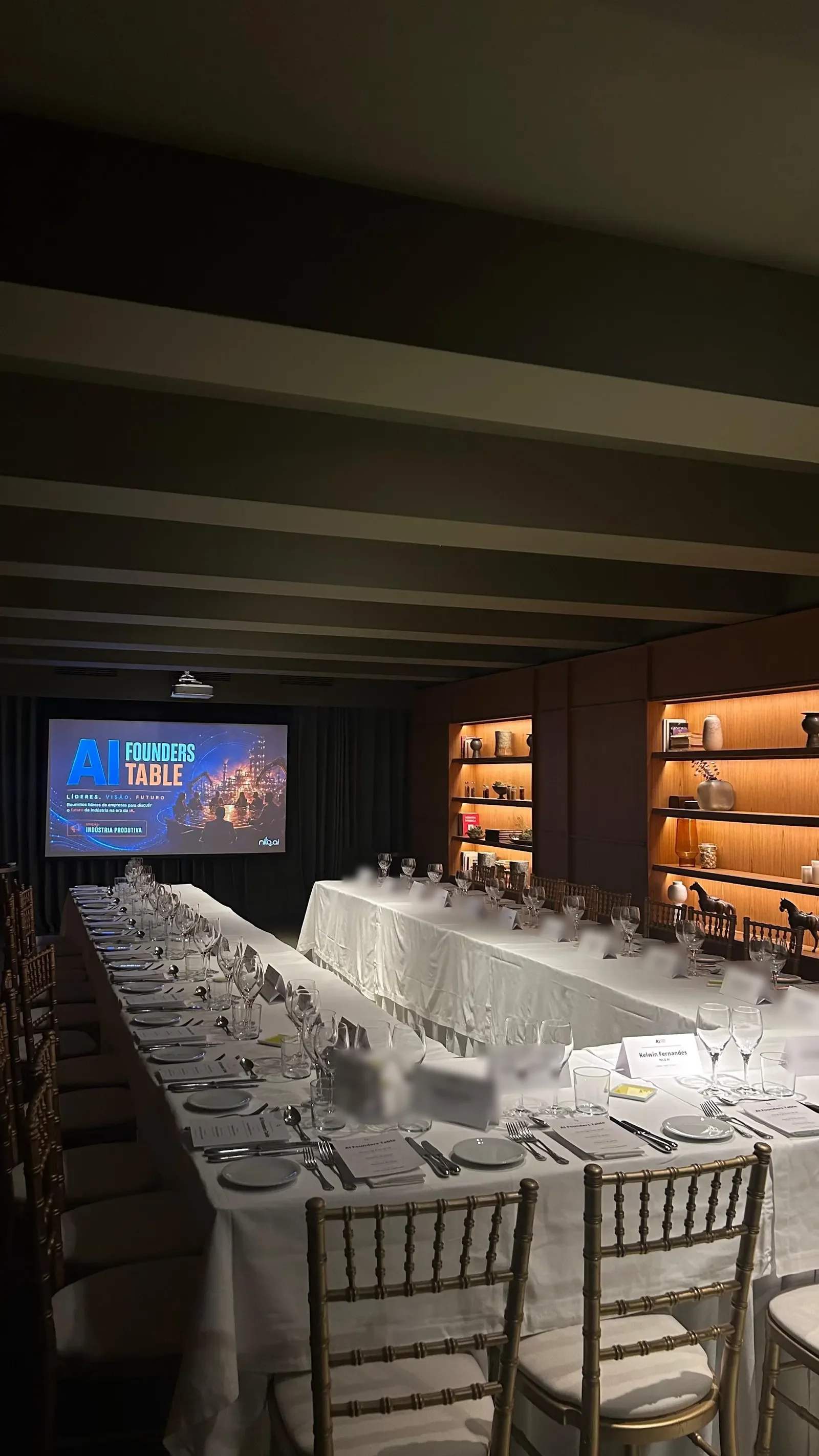 The set table of the manufacturing edition, lit by the room's shelves